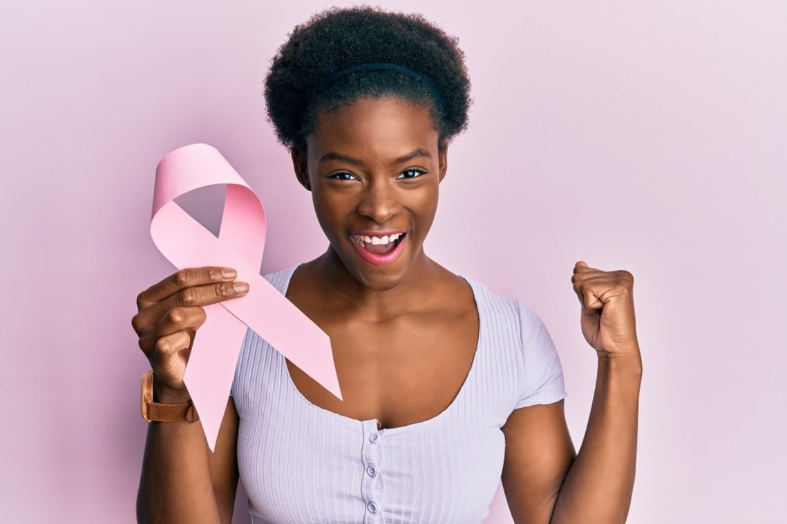 breast cancer awareness month woman holding pink ribbon