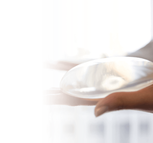 Image of a hand holding a breast implant