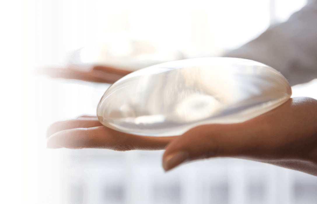 Image of a hand holding a breast implant